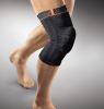 Compression knee brace with a silicone ring pad